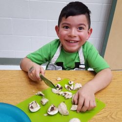 boy cutting mushrooms