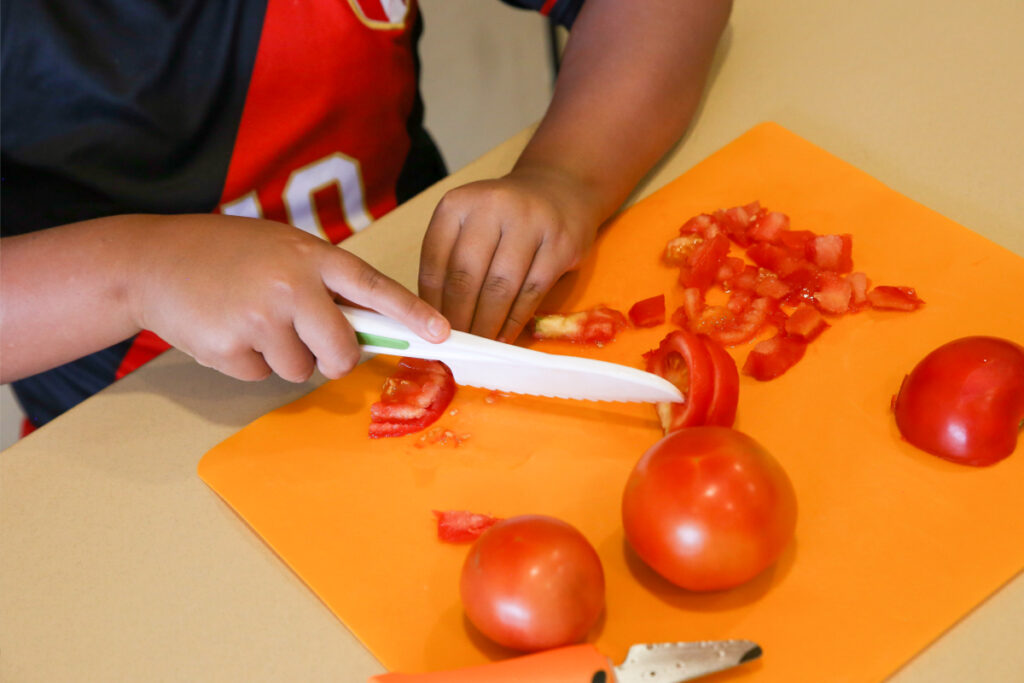 Slicing tomatoes, Homegrown EATS Camp at the Swaner EcoCenter